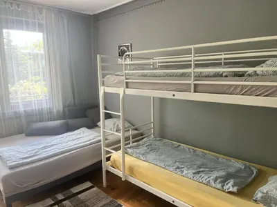 a bedroom with a desk with chairs and a bed at 4 Couples Hostel in Kraków