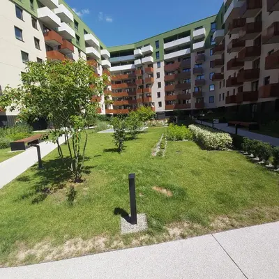 a garden in the middle of a building at Urban Oasis with a garage in Kraków