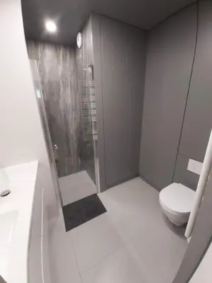 a bathroom with a shower and a toilet at Urban Oasis with a garage in Kraków