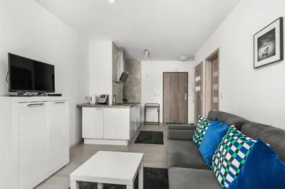 a living room with a couch and a table at Bronowice Modern Apartment by BookingHost in Kraków