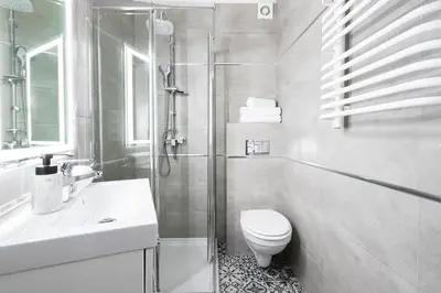 a bathroom with a shower and a toilet and a sink at Native Apartments Starowiślna 33A in Kraków
