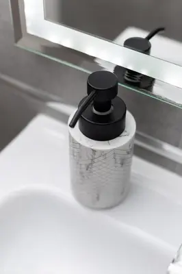 a cup with a black top sitting on a counter at Native Apartments Starowiślna 33A in Kraków
