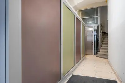 a hallway with a door and a stairway at Heart of Cracow Old Town Apartment by BookingHost in Kraków