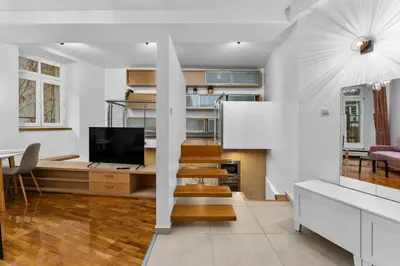 a living room with a tv and a dining room at Heart of Cracow Old Town Apartment by BookingHost in Kraków