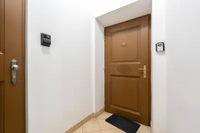 a hallway with a door and a tile floor at Heart of Cracow Old Town Apartment by BookingHost in Kraków