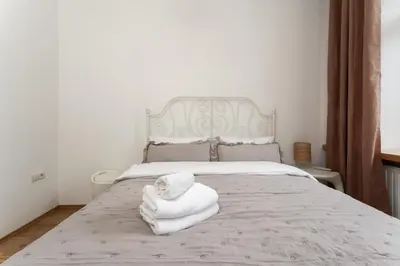 a bedroom with a bed with towels on it at Heart of Cracow Old Town Apartment by BookingHost in Kraków