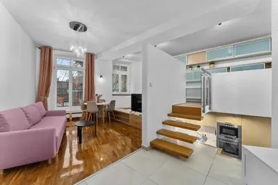 a living room with a purple couch and a tv at Heart of Cracow Old Town Apartment by BookingHost in Kraków