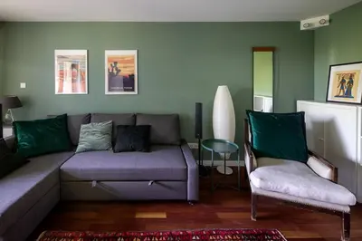 a living room with a couch and a chair at Unique riverside treasure in Kraków