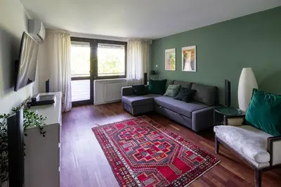 a living room with a couch and a rug at Unique riverside treasure in Kraków