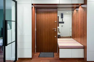a wooden door with a bench in a room at Unique riverside treasure in Kraków