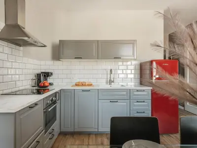 a kitchen with white cabinets and a red refrigerator at Bohemian Suites by Fragola Apartments in Kraków