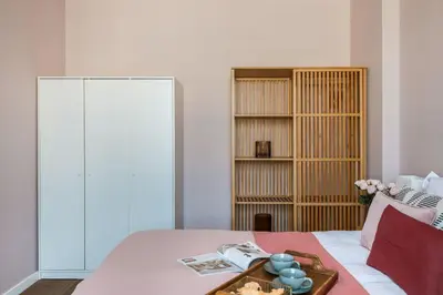 a bathroom with two sinks and a toilet and a shower at Bohemian Suites by Fragola Apartments in Kraków