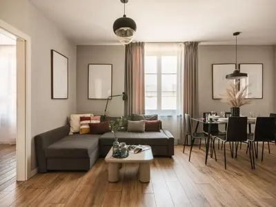 a dining room with a black table and chairs at Bohemian Suites by Fragola Apartments in Kraków
