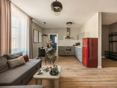 a living room with a couch and a red refrigerator at Bohemian Suites by Fragola Apartments in Kraków