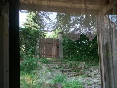 a window view of a yard with a fence at Holiday Home mit Wasserblick by Interhome in Kraków