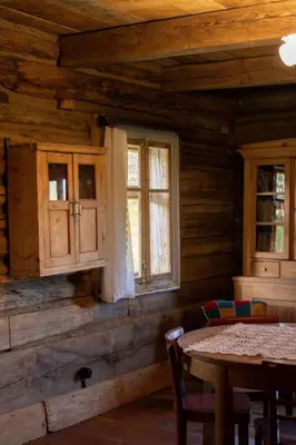a dining room with a table and two windows at Holiday Home mit Wasserblick by Interhome in Kraków
