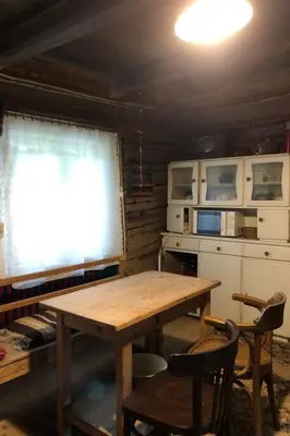 a kitchen with a wooden table and a window at Holiday Home mit Wasserblick by Interhome in Kraków