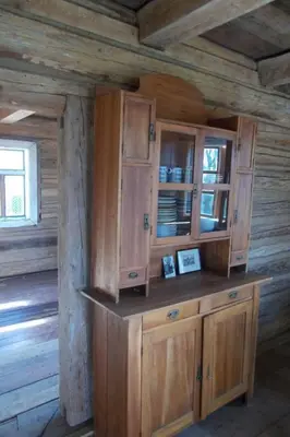 a kitchen with wooden cabinets in a log cabin at Holiday Home mit Wasserblick by Interhome in Zawada