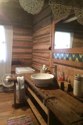 a bathroom with a sink on a wooden counter at Holiday Home mit Wasserblick by Interhome in Zawada