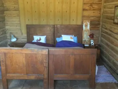 a bedroom with a wooden bed in a cabin at Holiday Home mit Wasserblick by Interhome in Zawada