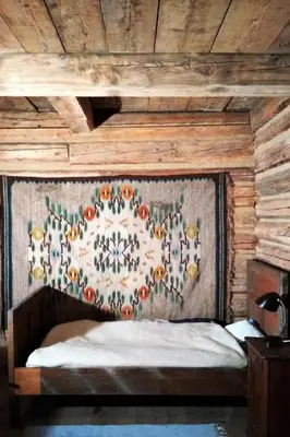 a bedroom with a bed with a tapestry on the wall at Holiday Home mit Wasserblick by Interhome in Zawada