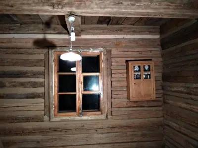 a room with a window in a log cabin at Holiday Home mit Wasserblick by Interhome in Zawada