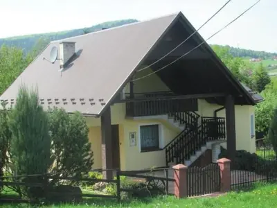 a small yellow house with a black roof at Holiday Home Haus Sonne by Interhome in Nowe Rybie