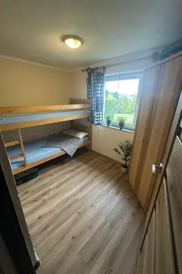 a room with a bunk bed and a window at Holiday Home Haus Sonne by Interhome in Nowe Rybie