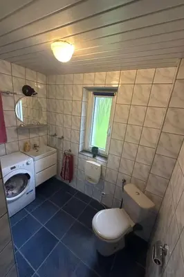 a small bathroom with a toilet and a sink at Holiday Home Haus Sonne by Interhome in Nowe Rybie
