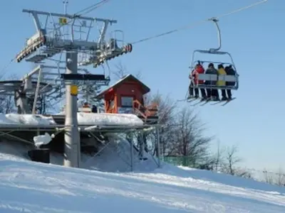 a group of people riding a ski lift in the snow at Holiday Home Haus Sonne by Interhome in Nowe Rybie