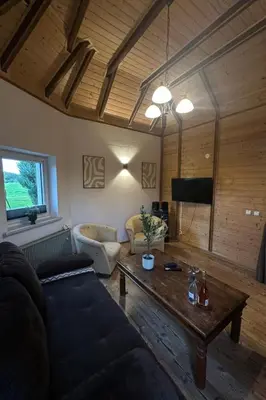 a living room with a couch and a table at Holiday Home Haus Sonne by Interhome in Nowe Rybie