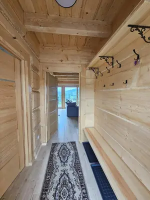 a room with wooden walls and a hallway with a rug at Babiogórski Azyl & SPA in Zawoja