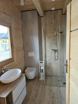 a bathroom with a shower and a toilet and a sink at Babiogórski Azyl & SPA in Zawoja