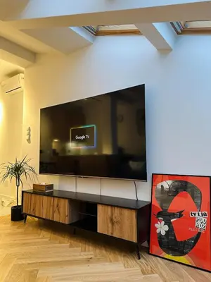 a living room with a large flat screen tv at Sky Studio Old Town in Kraków