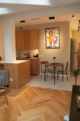a kitchen and living room with a table and chairs at Sky Studio Old Town in Kraków