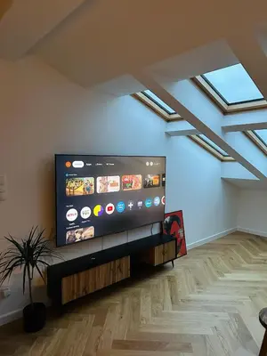 a living room with a large flat screen tv at Sky Studio Old Town in Kraków