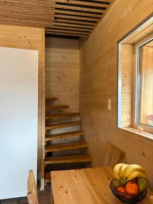 a wooden room with a table with fruit on it at Zacisze z Balia in Łostówka