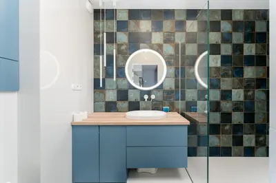 a bathroom with a blue sink and a mirror at Zabłocie Harmony Apartment by BookingHost in Kraków