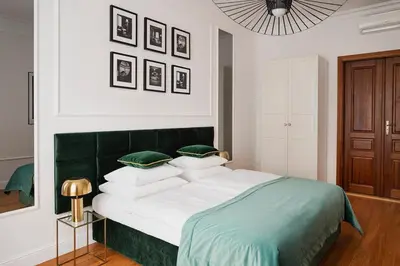 a bedroom with a green and white bed with pillows at QUEEN #2 APARTMENT, WAWEL VIEW, OLD TOWN, Kraków in Kraków