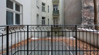 a black fence in front of a building at Rakowicka Residence, Sun & Snow in Kraków