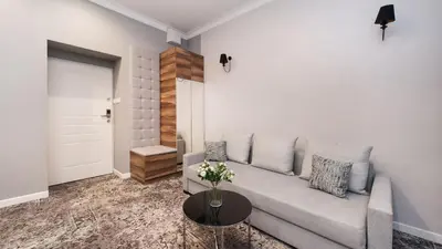 a bedroom with a large white bed with black pillows at Rakowicka Residence, Sun & Snow in Kraków