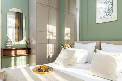 a bedroom with green walls and a bed and a table at Perfect Apartment in the Old Town 5min Market Square AC WiFi Parking in Kraków