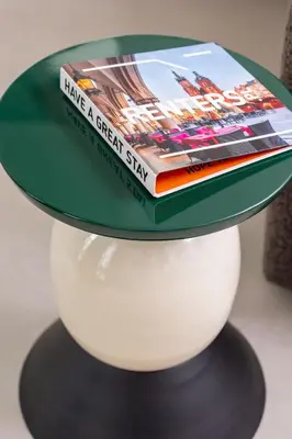 a green hat with a book on top of a shelf at Stylish Apartment with Underground Parking Located Near the TAURON Arena by Noclegi Renters in Kraków