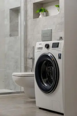 a washing machine in a bathroom next to a toilet at Bright One-Bedroom Apartment Functional Interiors Remote Working by Noclegi Renters in Kraków