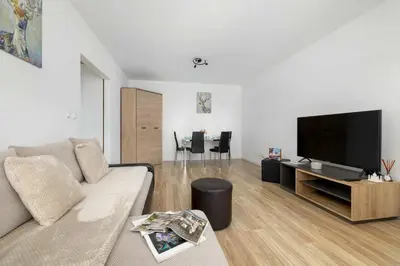 a living room with a couch and a flat screen tv at Bright One-Bedroom Apartment Functional Interiors Remote Working by Noclegi Renters in Kraków