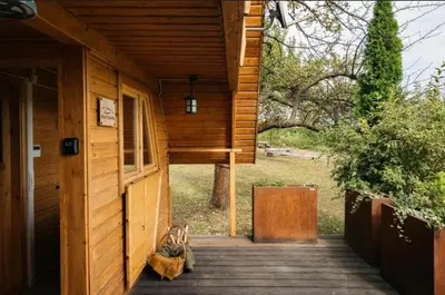 a kitchen in a log cabin with a table and chairs at Mała Toskania