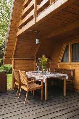 a wooden deck with a table and chairs on it at Mała Toskania
