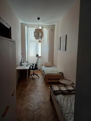 a small room with a desk and a bed and a desk sidx sidx sidx sidx at city center 2 rooms 1 kitchen in Kraków