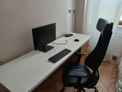 a white desk with a computer and a chair at city center 2 rooms 1 kitchen in Kraków