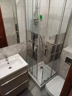 a bathroom with a shower and a toilet and a sink at city center 2 rooms 1 kitchen in Kraków